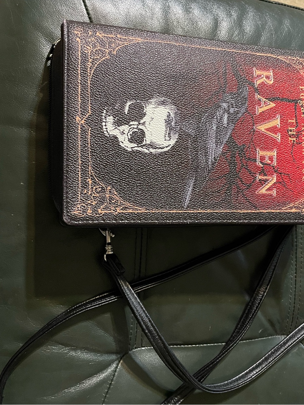 The Raven Crossbody Bag - Black and Red looks like a book, along with wallet